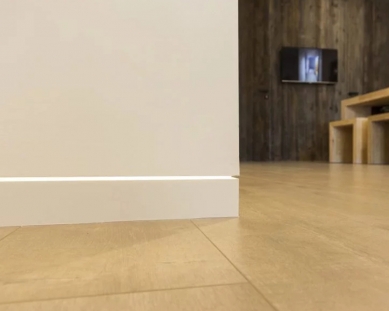 Hidden plinth strip DORSIS – a small technical detail with a big visual effect - Hidden skirting board Linus with embedded LED strip